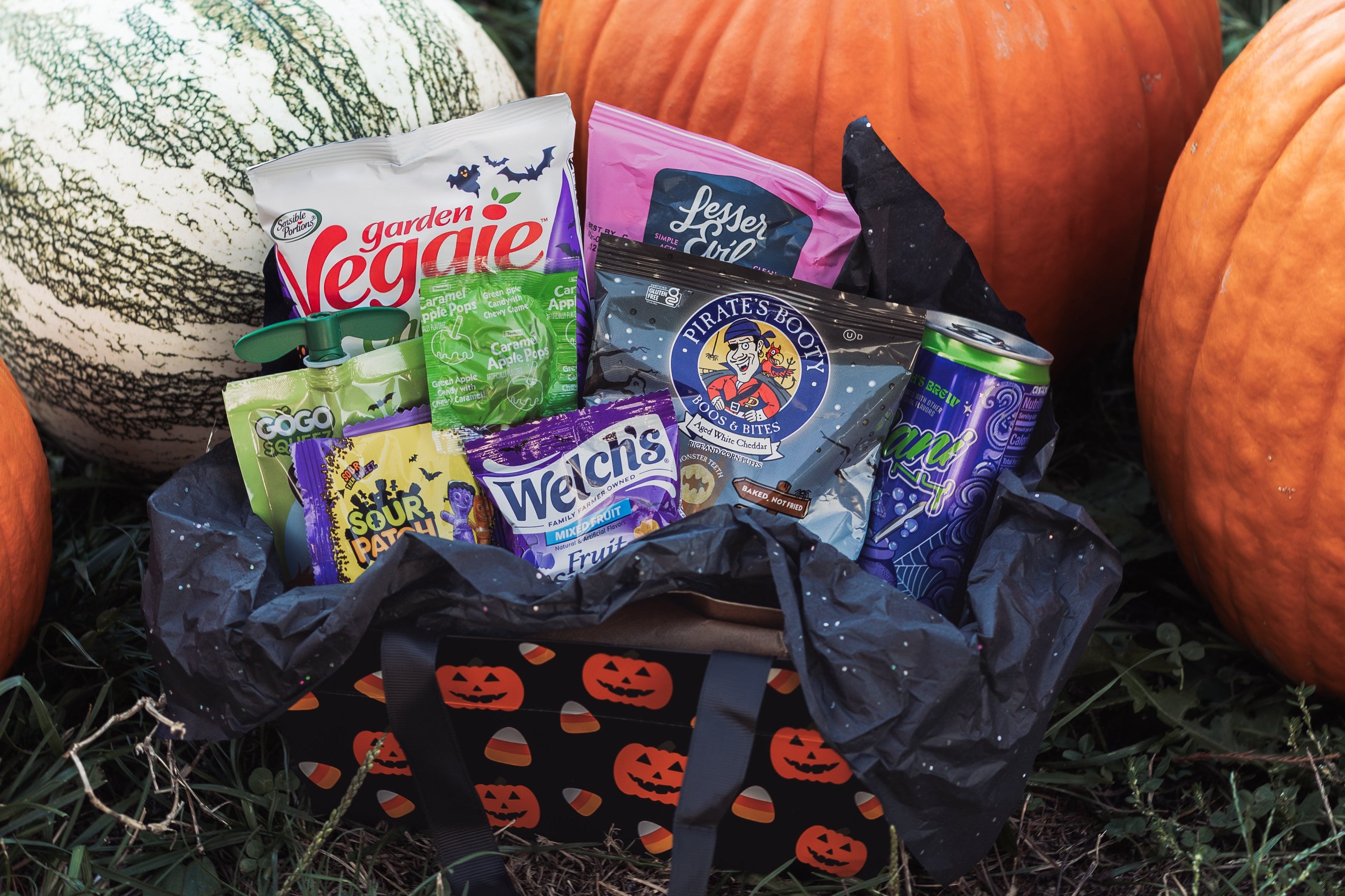 Glutique Halloween Boo Box filled with gluten-free snacks, candy, and drinks in festive pumpkin packaging — the perfect fall-themed gift basket for college students.