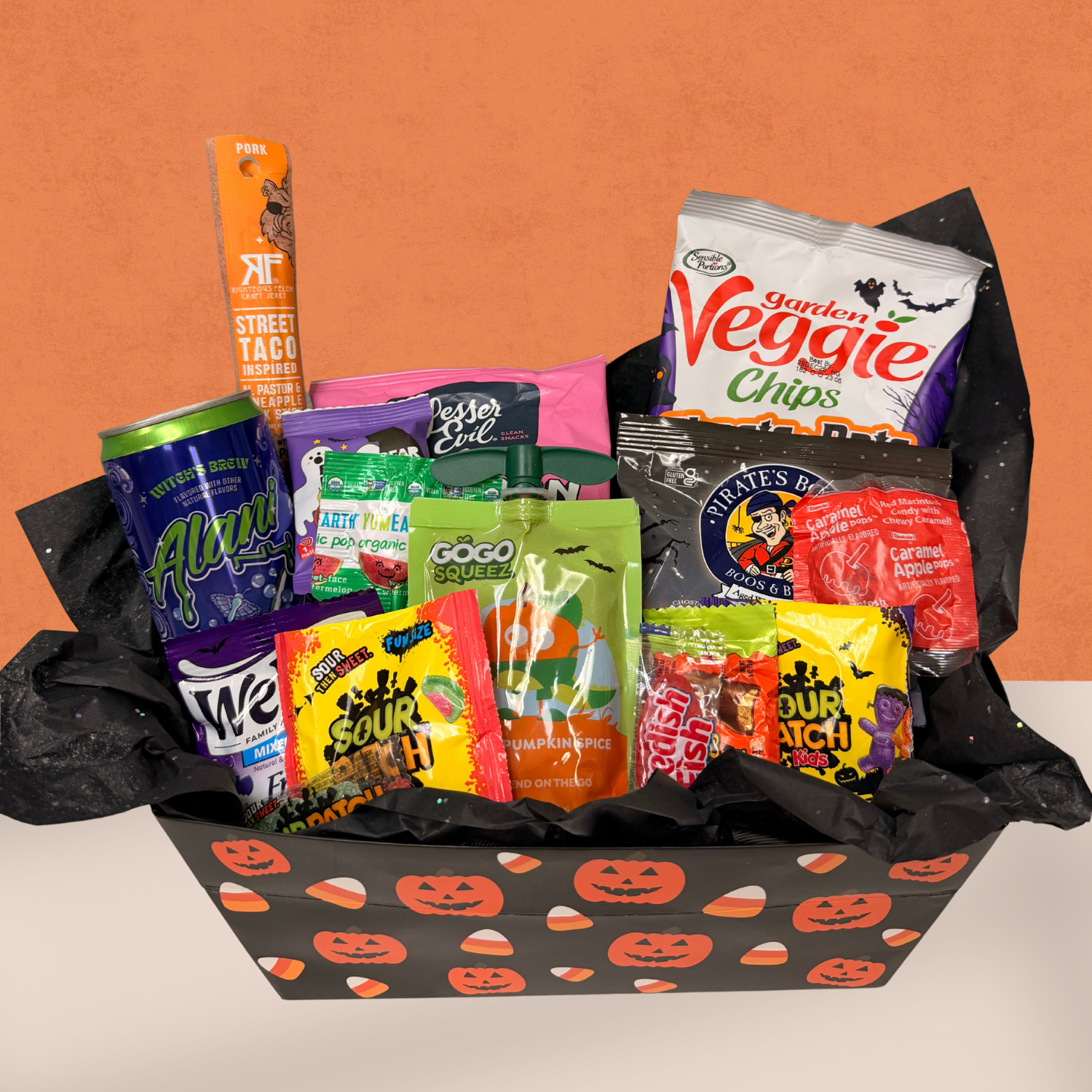 Halloween Boo Box filled with gluten-free snacks, candy, and drinks in festive pumpkin packaging by Glutique