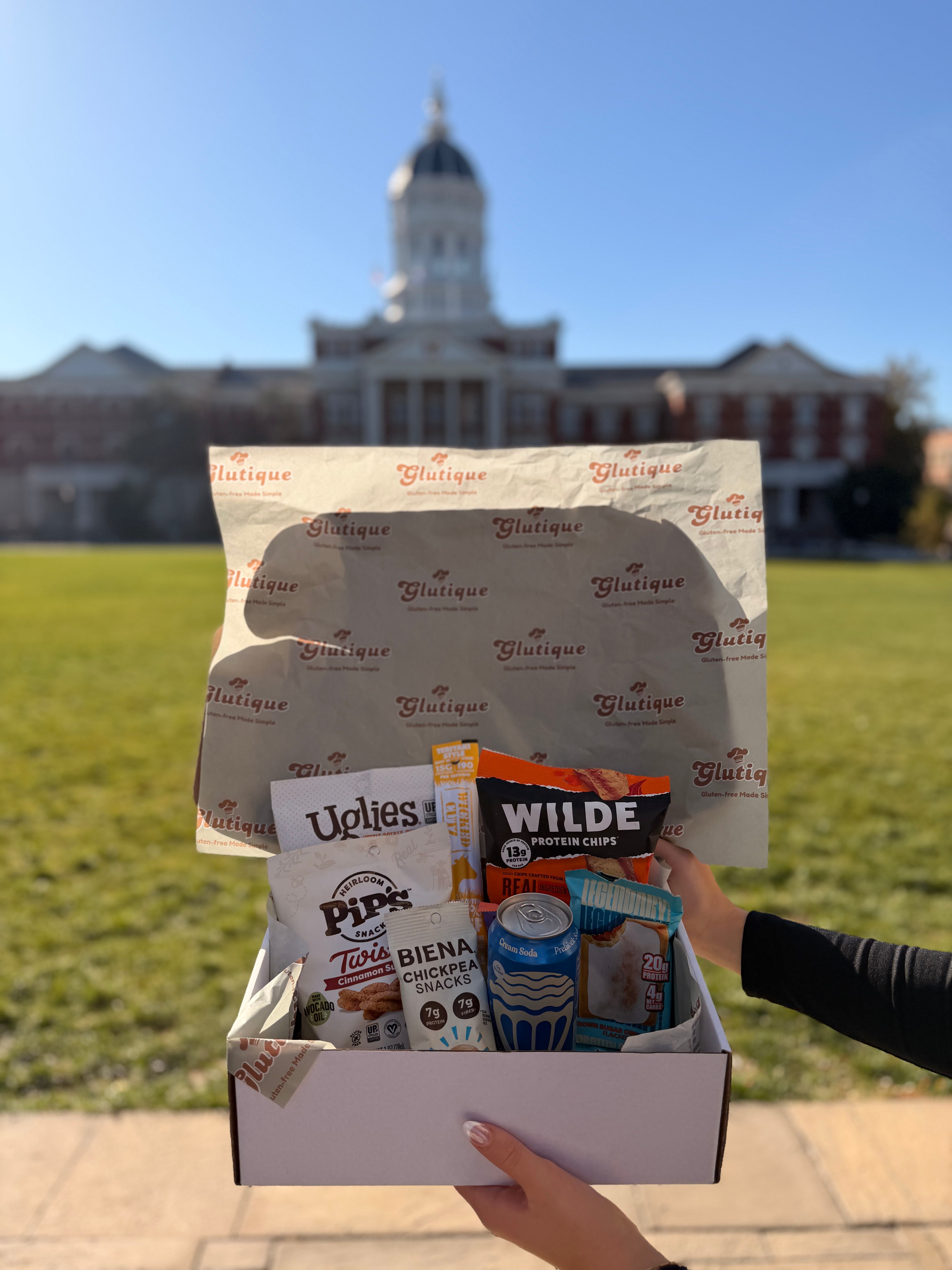 Mizzou-Student-Holding-Gluten-Free Snac-Bkox-at-The-Columns-University-of Missouri-Campus